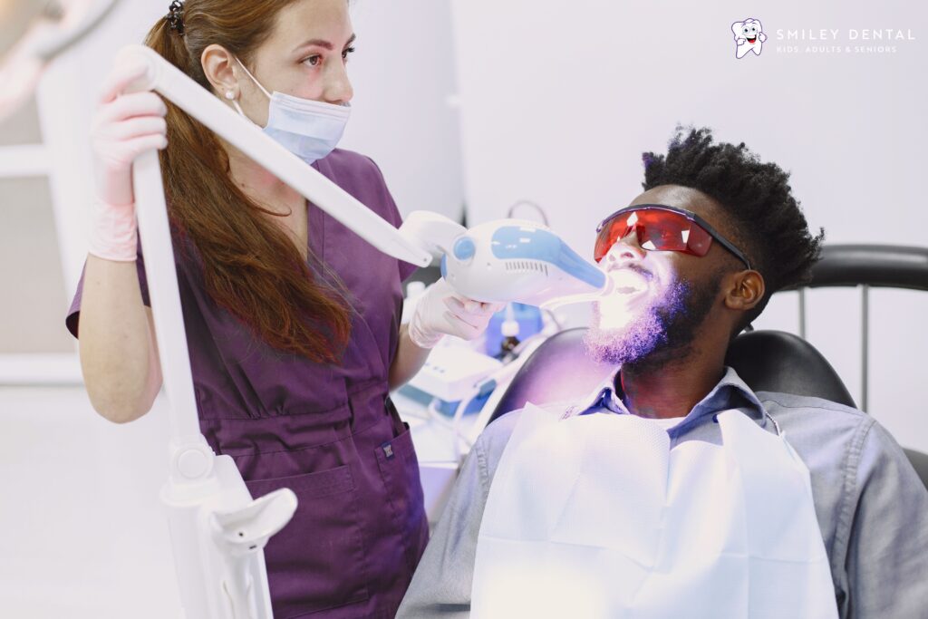 Patient receiving professional teeth whitening treatment at a dental clinic