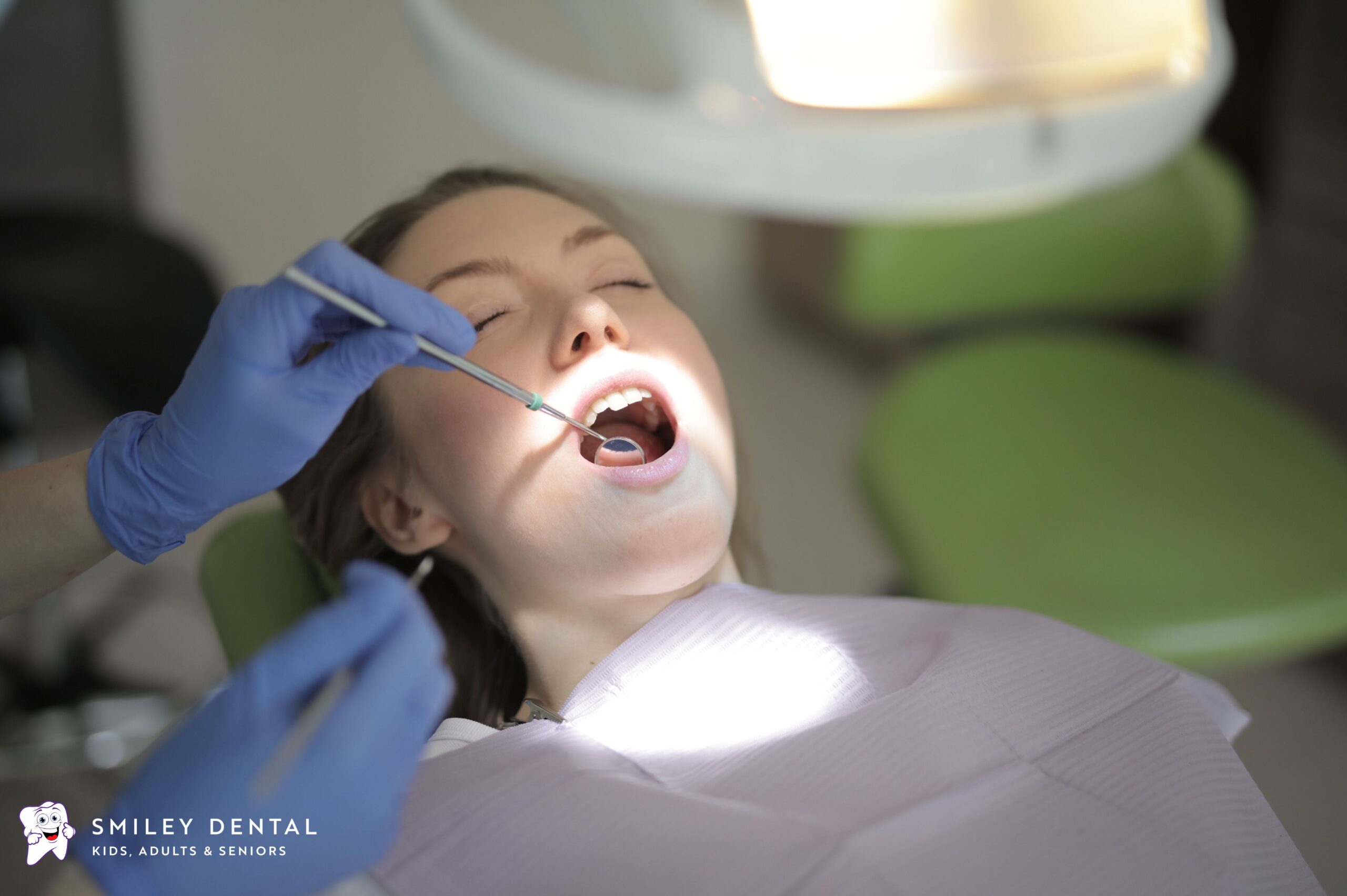 Emergency dentist checking a patient's tooth pain during a dental exam in Beverly MA
