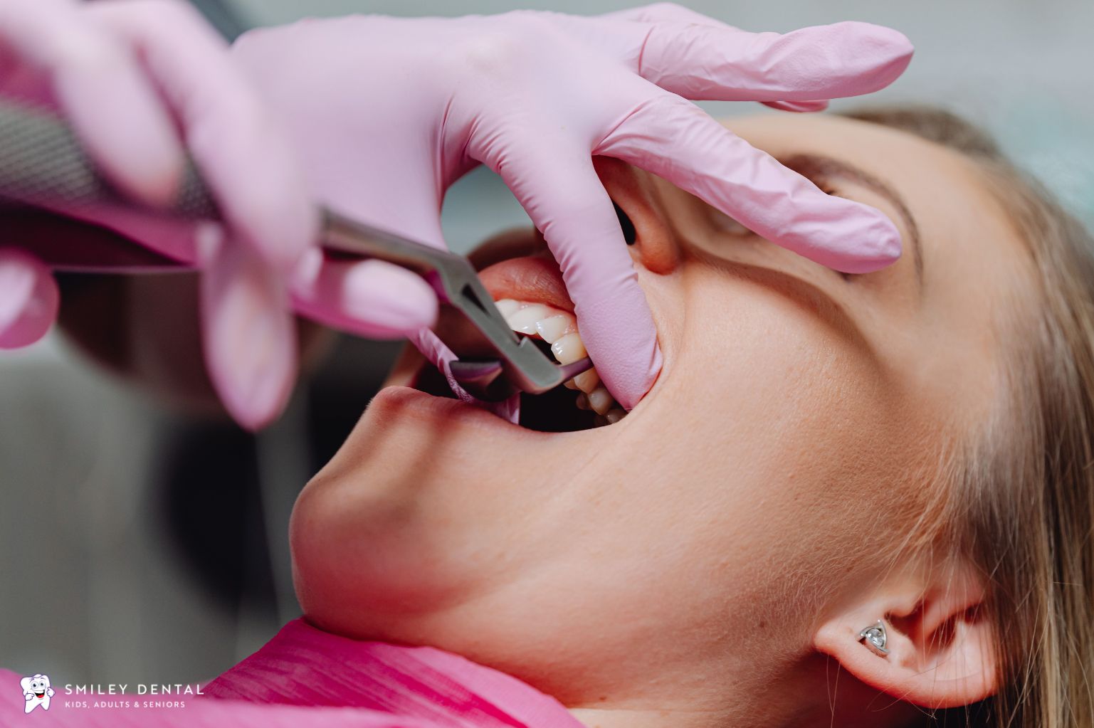 Dentist examining a patient's teeth and gums during a dental appointment
