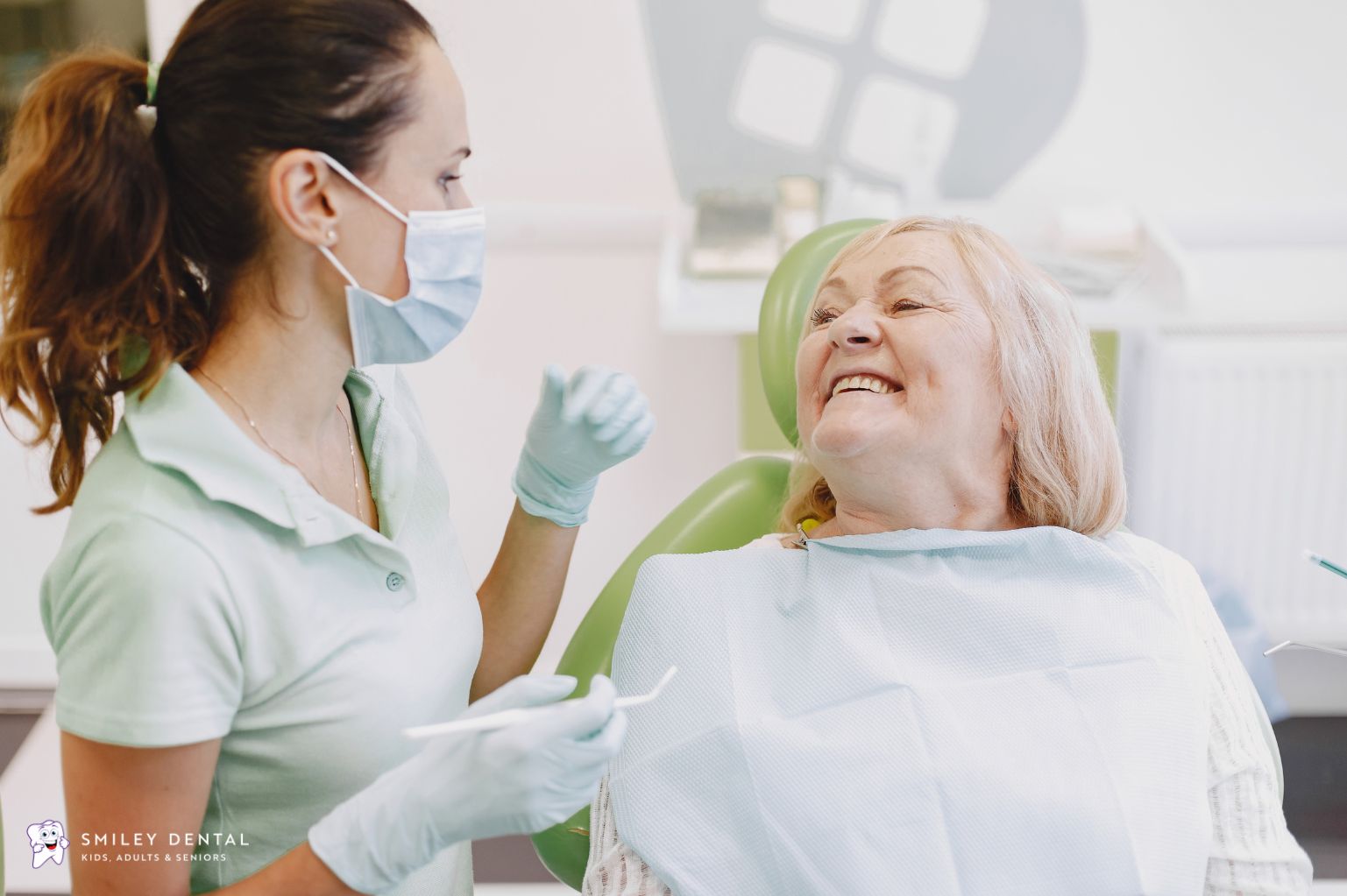 Dentist providing a dental checkup for an older adult in Beverly, Massachusetts